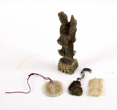 A jade carving of a figure standing 2dd367