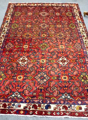 A Hamadan rug with claret ground,