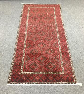 A Baluchi rug the red ground with 2dd3db