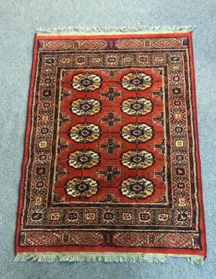 A machine made rug of Bokhara design,