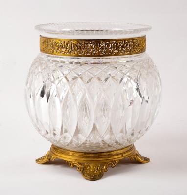 A cut glass vase with pierced gilt metal