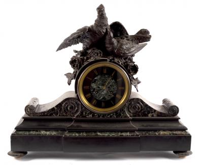 A black slate mounted clock with bird