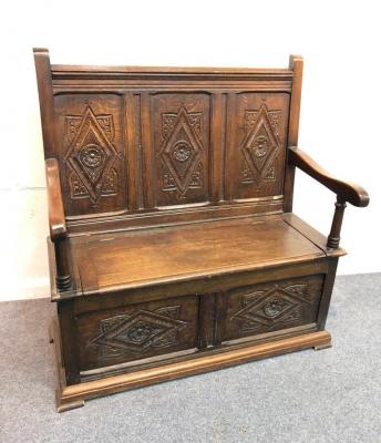 A 17th Century style oak settle with
