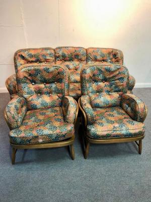 An Ercol sofa and two matching chairs,