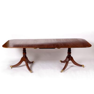 A mahogany two-pillar dining table with