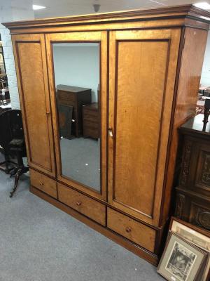 A large Victorian satinwood wardrobe