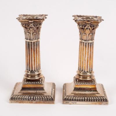 A pair of silver dwarf candlesticks