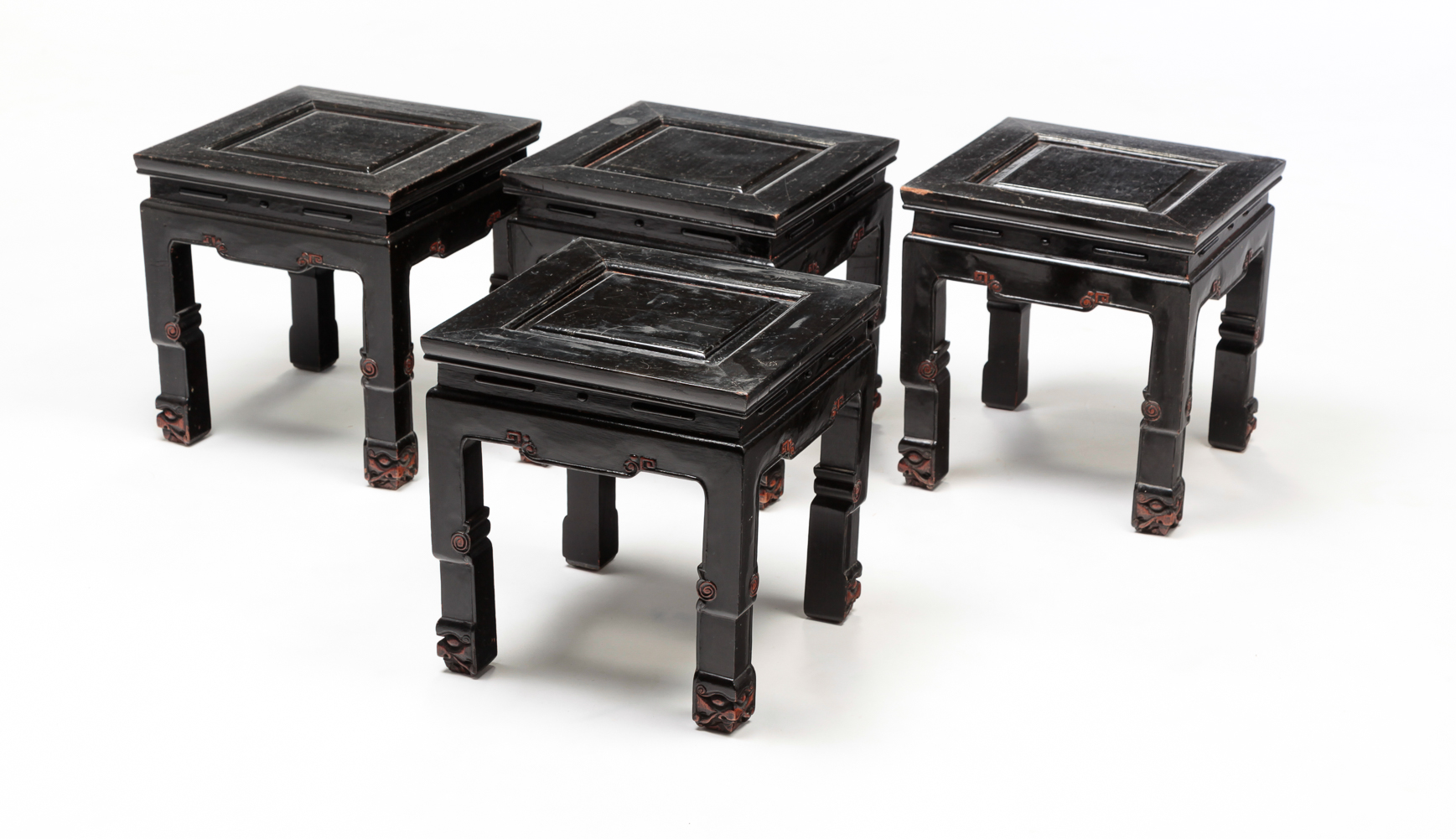 FOUR CHINESE LOW CARVED STANDS.