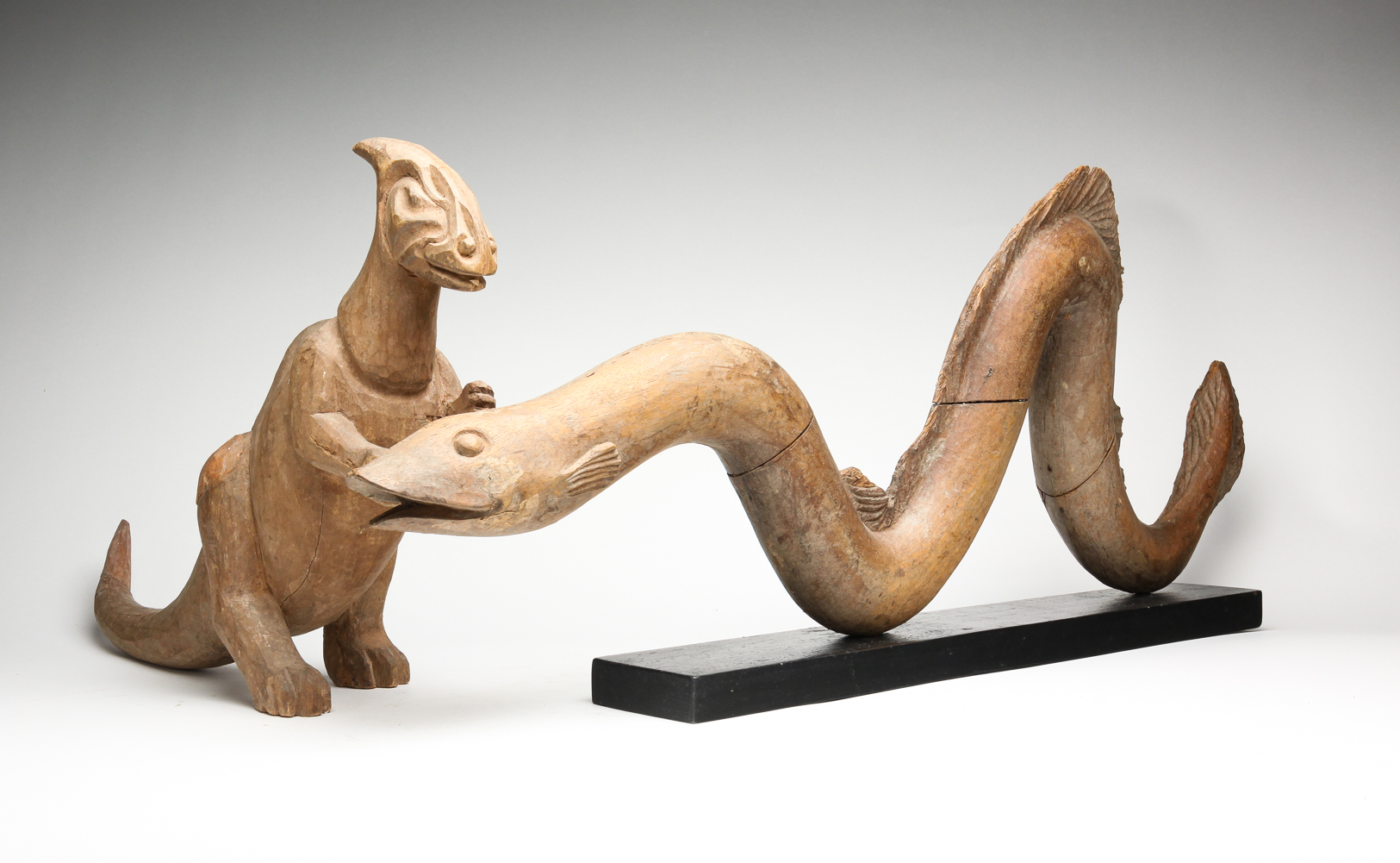 TWO WOODEN MOLDS OF DINOSAUR AND SERPENT.