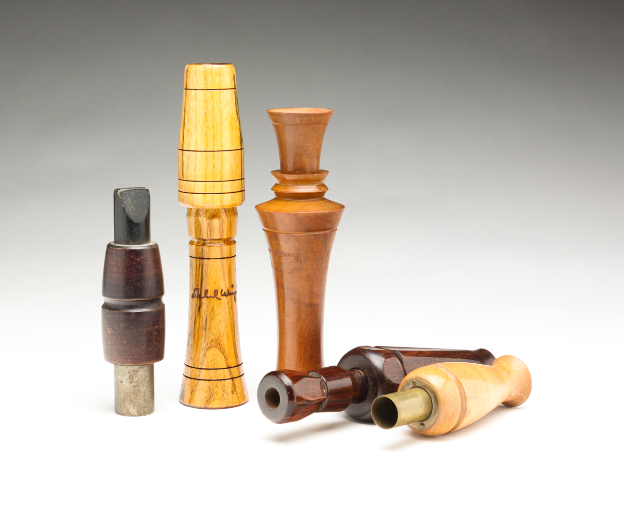 FIVE SIGNED WOODEN DUCK CALLS.