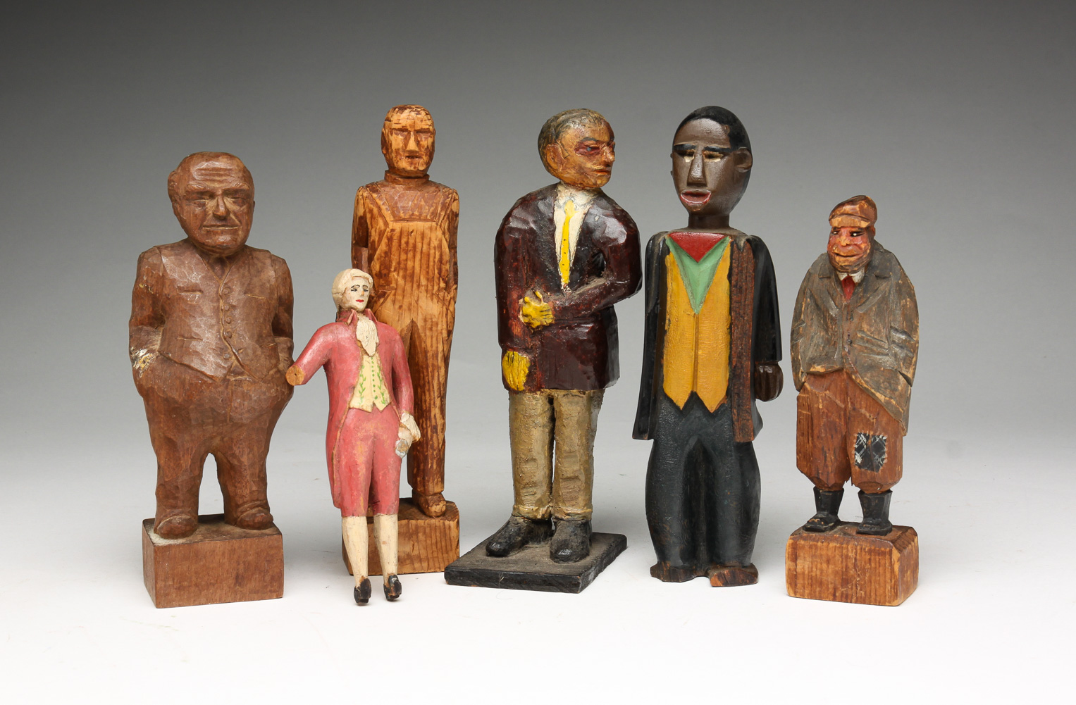 SIX FOLK ART CARVED MEN. American, 20th