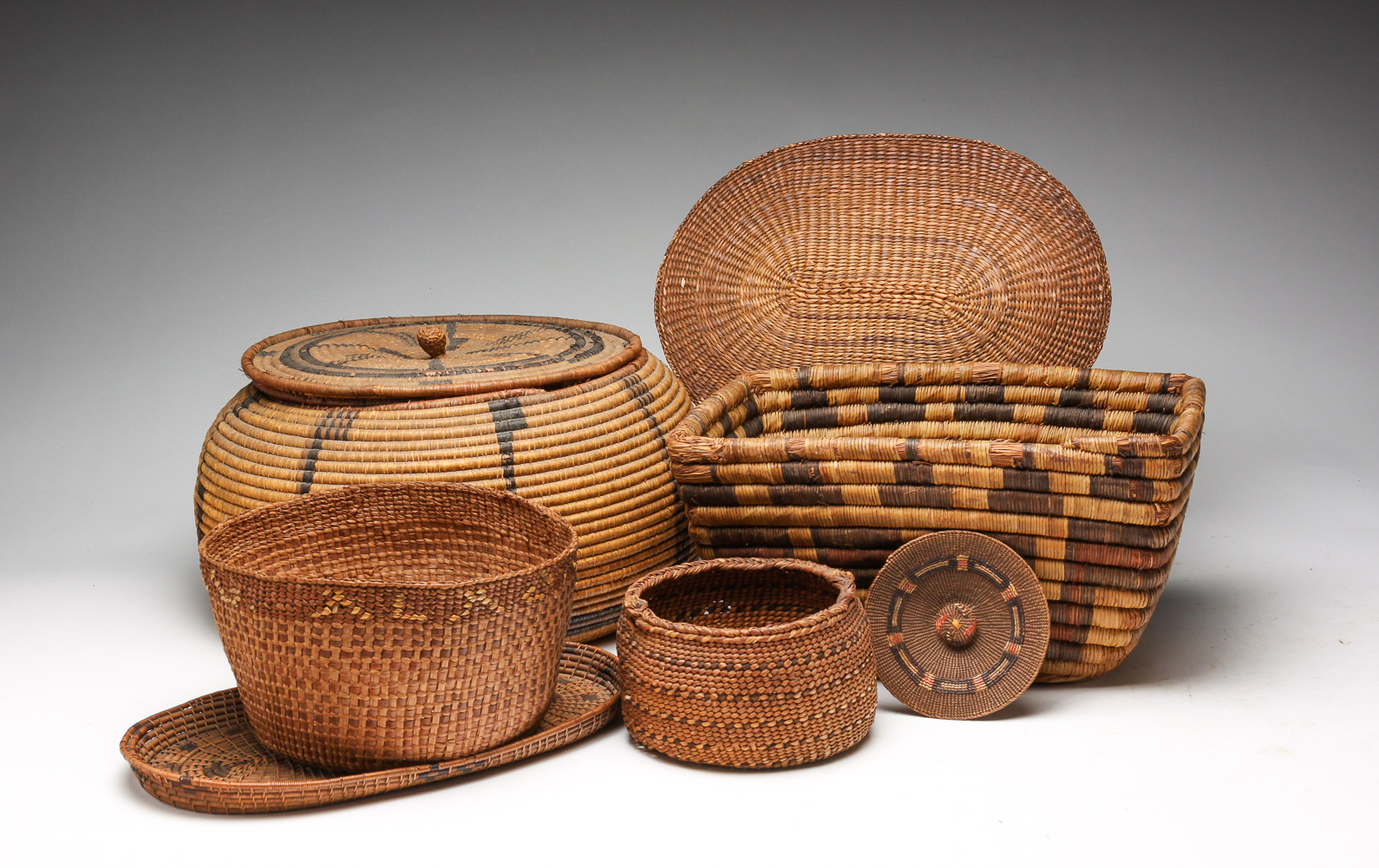 FOUR NATIVE AMERICAN BASKETS. Mid