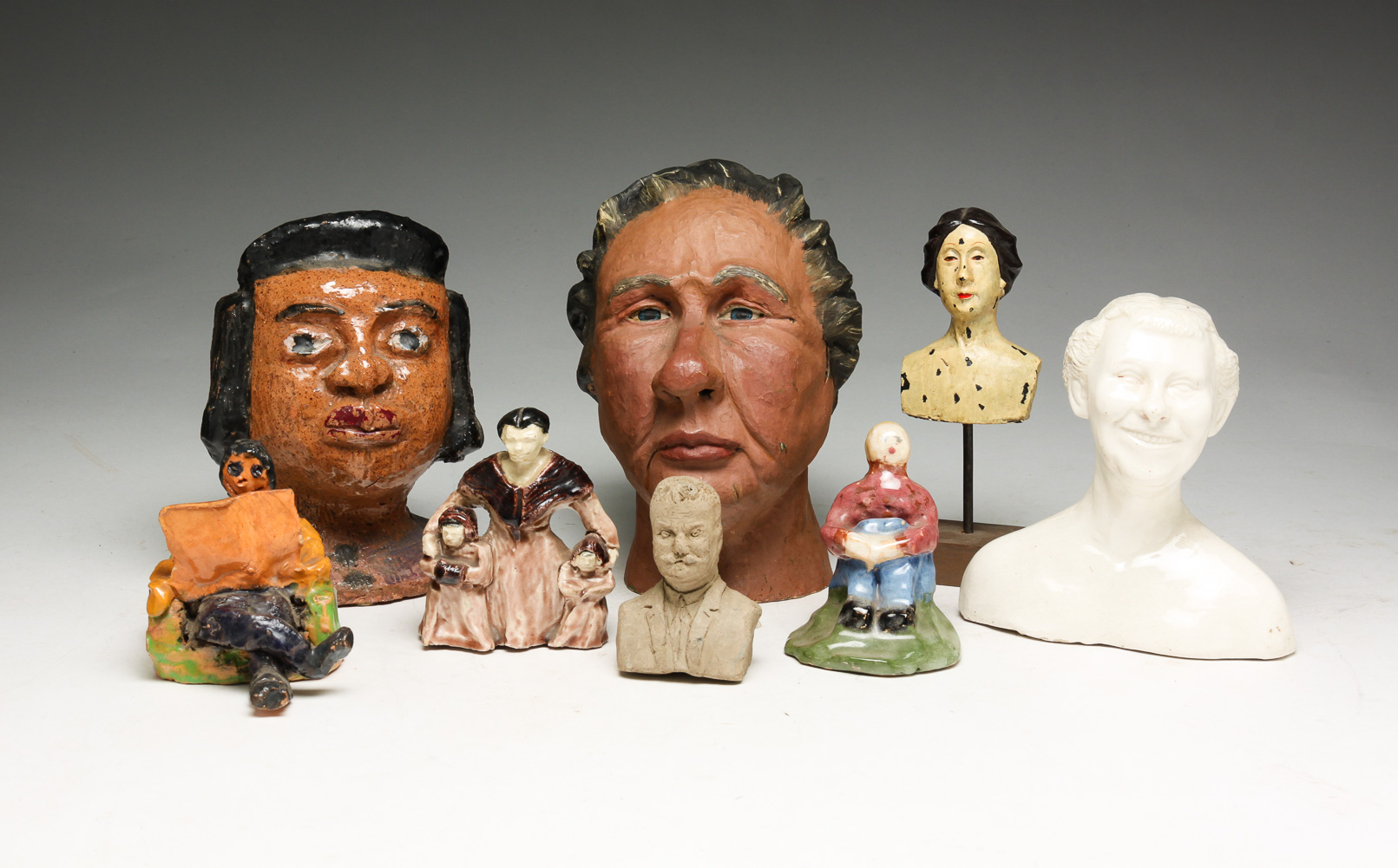 GROUP OF CERAMIC HEADS AND FIGURES.