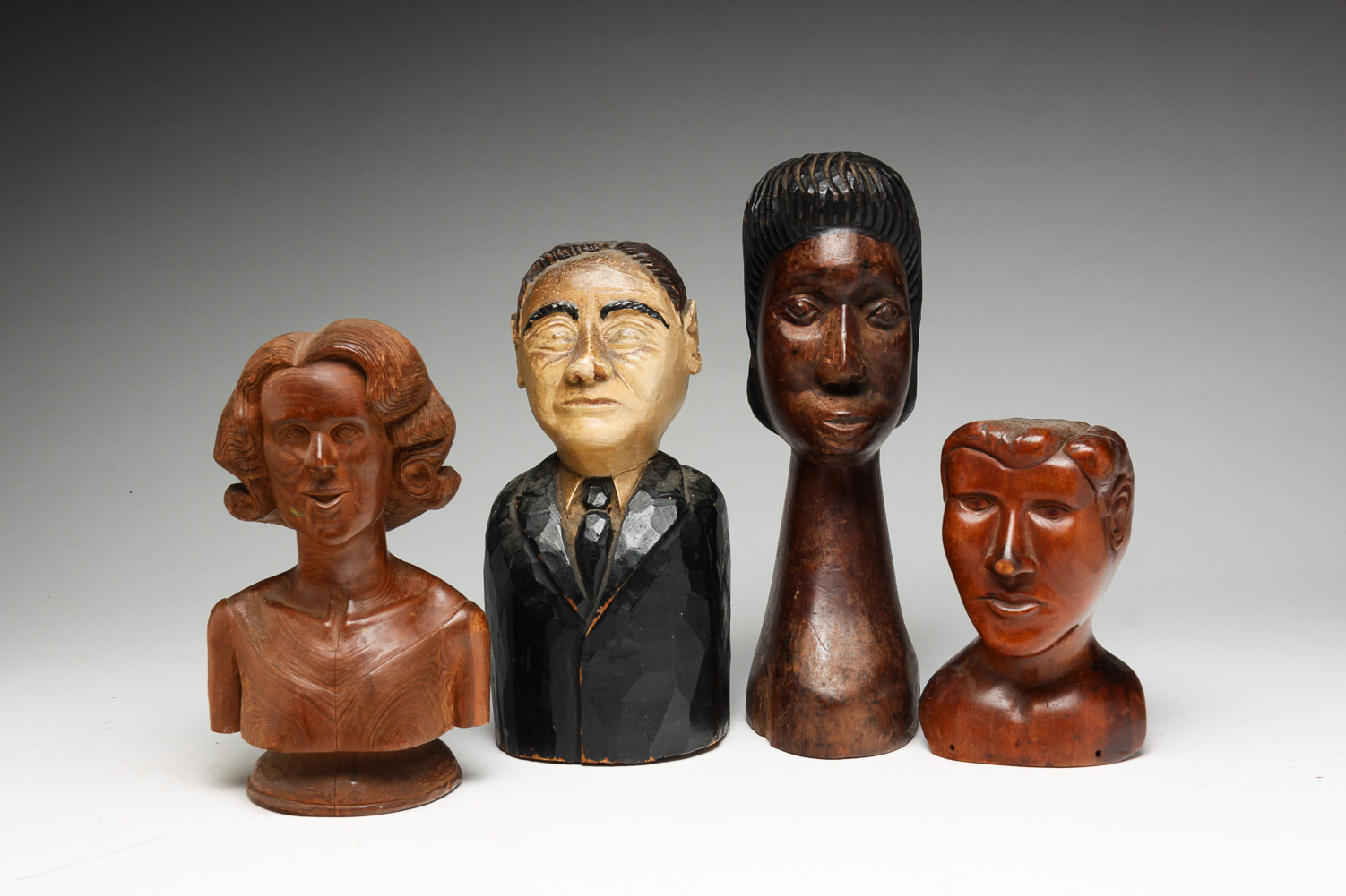 FOUR AMERICAN CARVED FOLK ART BUSTS.