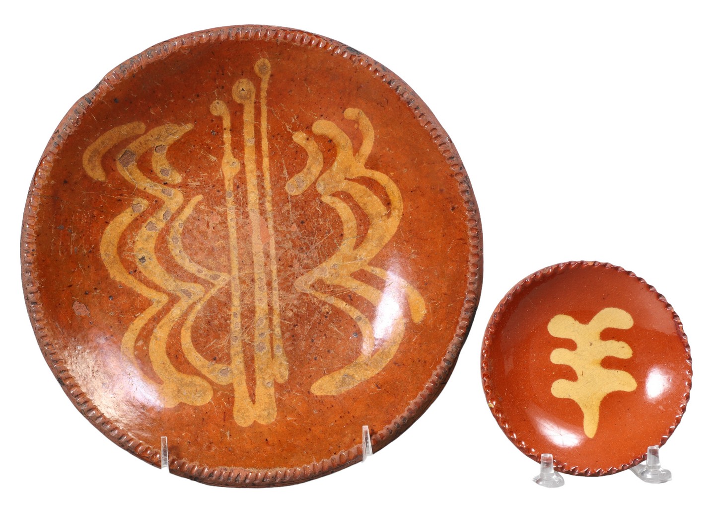 (2) Slip decorated redware plates, unmarked,