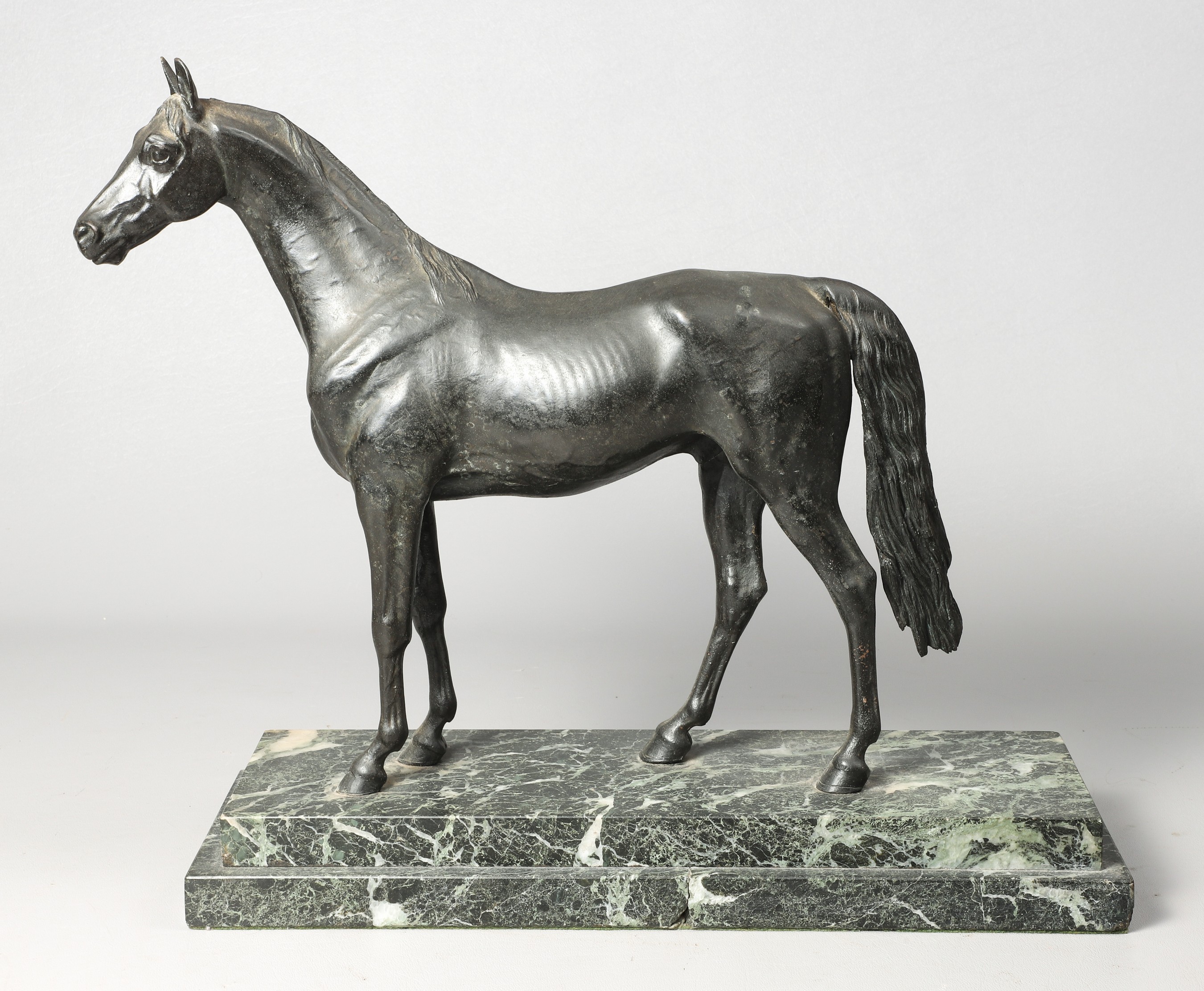A Bronze sculpture of a horse on tiered