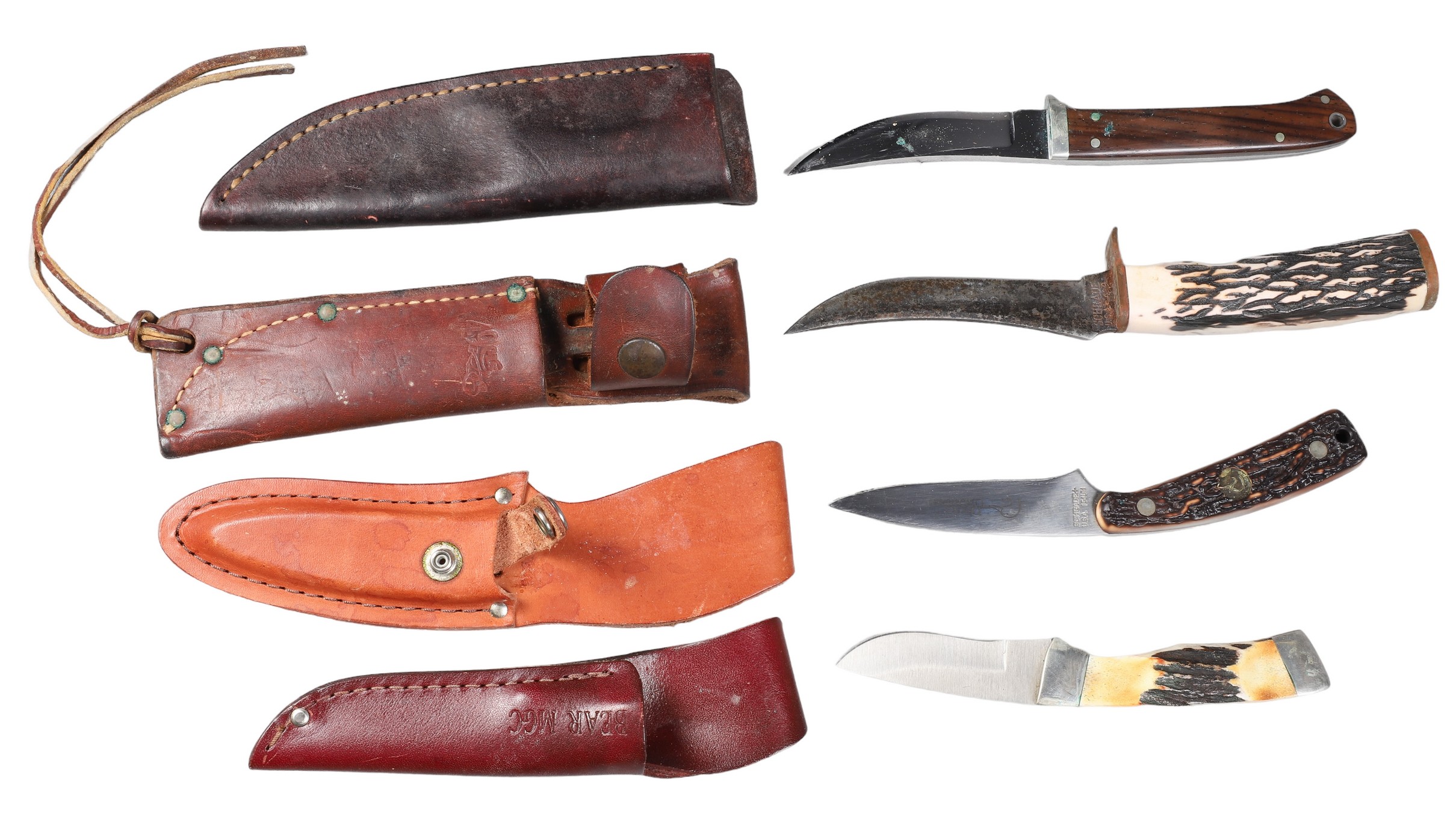 Four belt knives in leather sheaths,