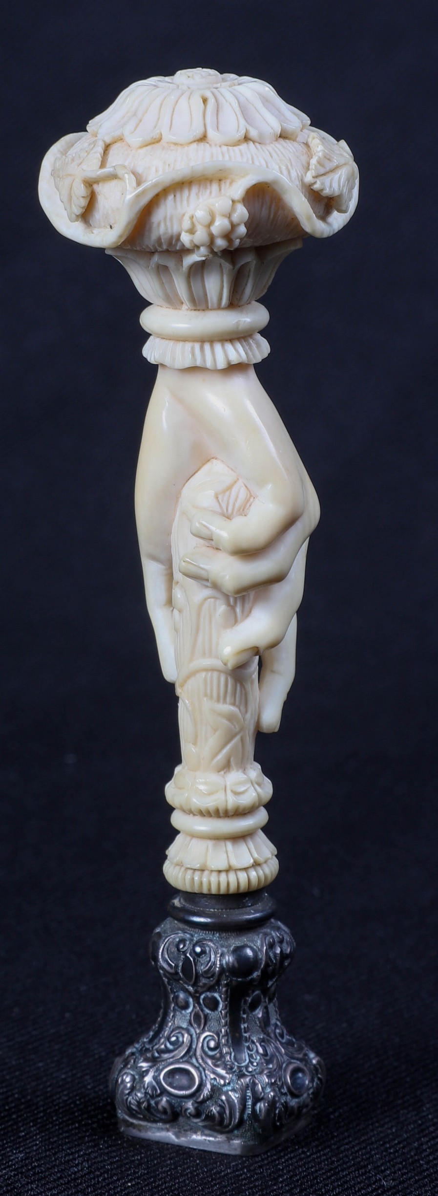 An ivory carved hand form seal,