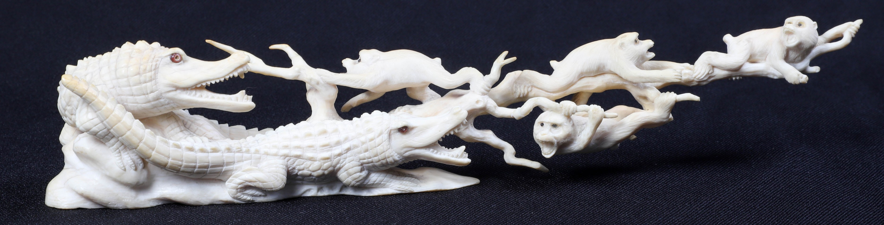 A single piece carved monkey and alligator