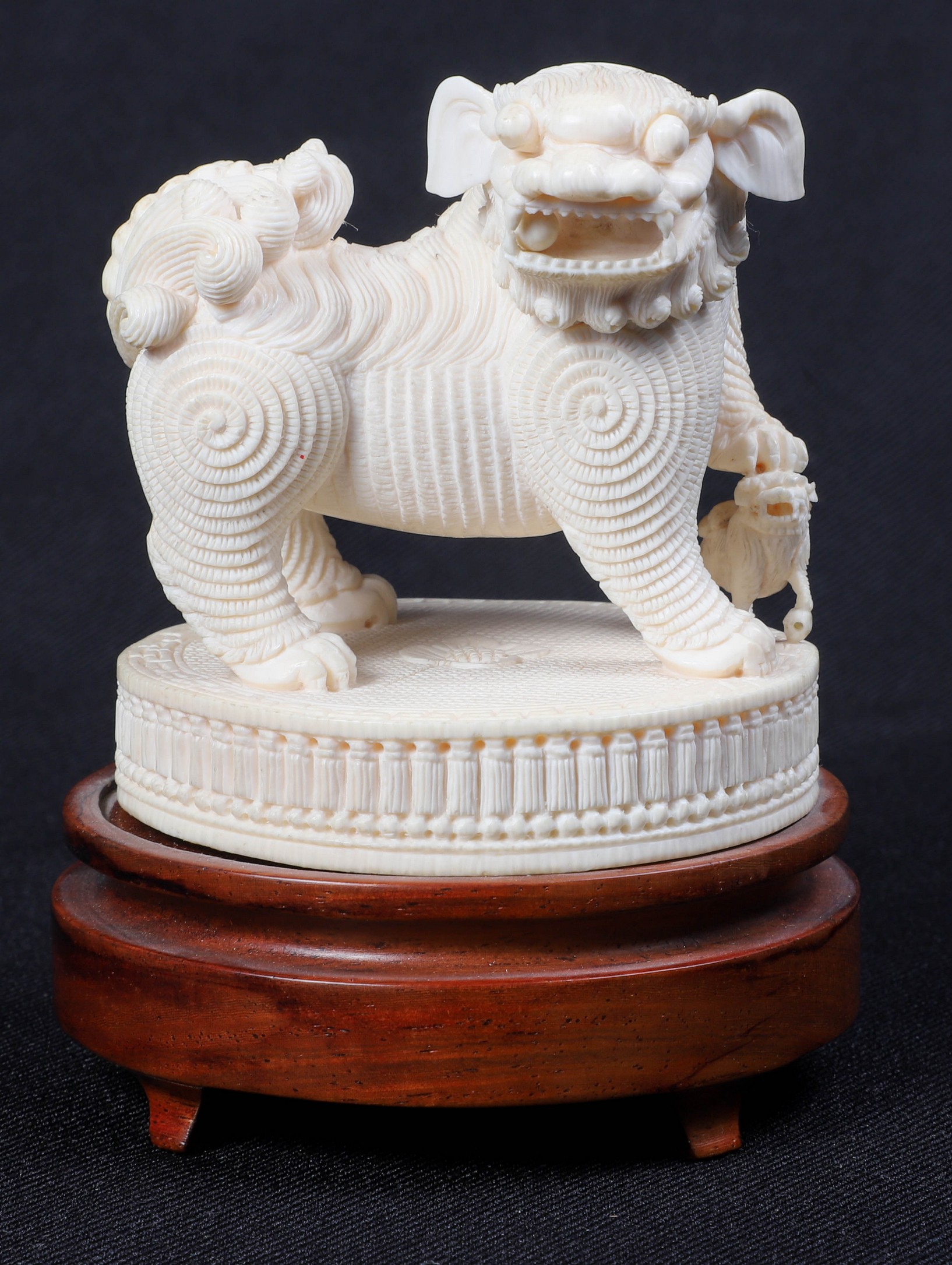 An ivory carved fu lion with cub,