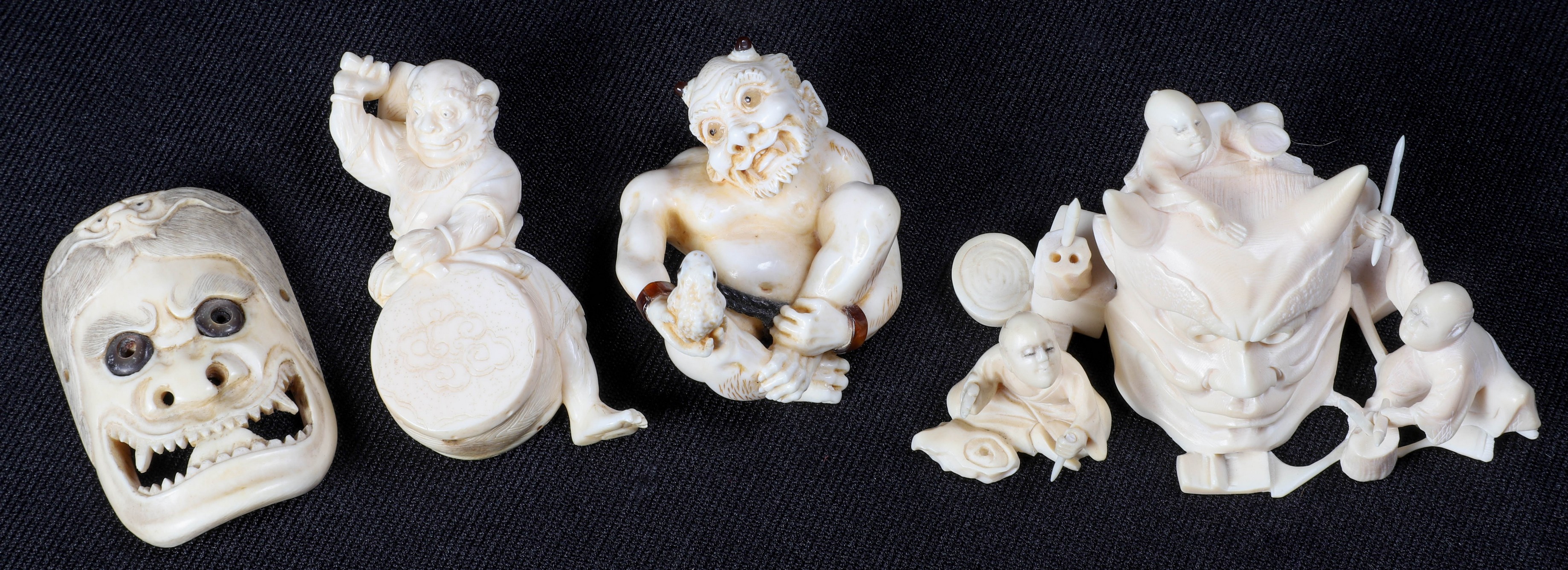  4 Oni masks and figures in ivory 2e0d0e