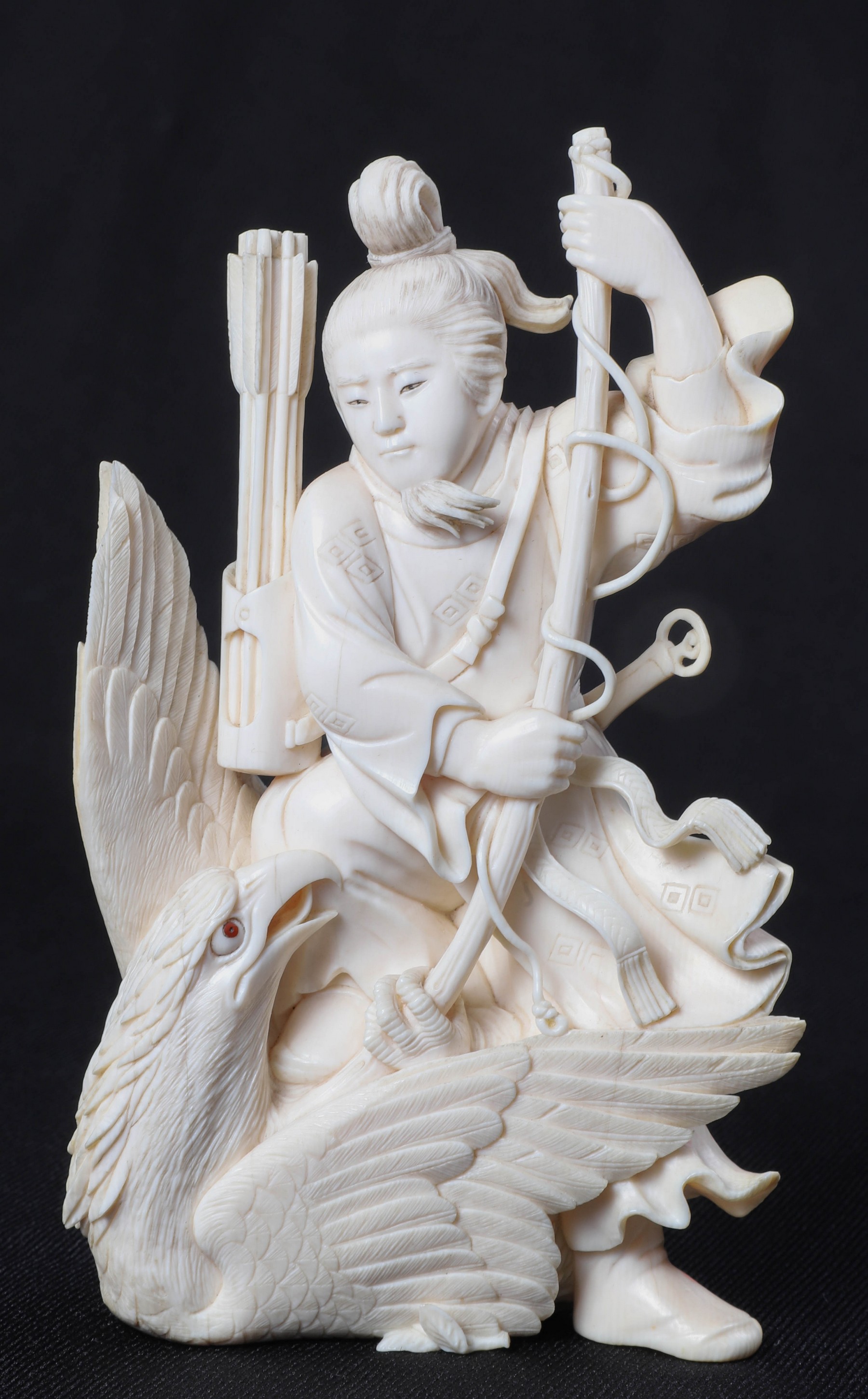 An ivory figure with hawk, robe adorned