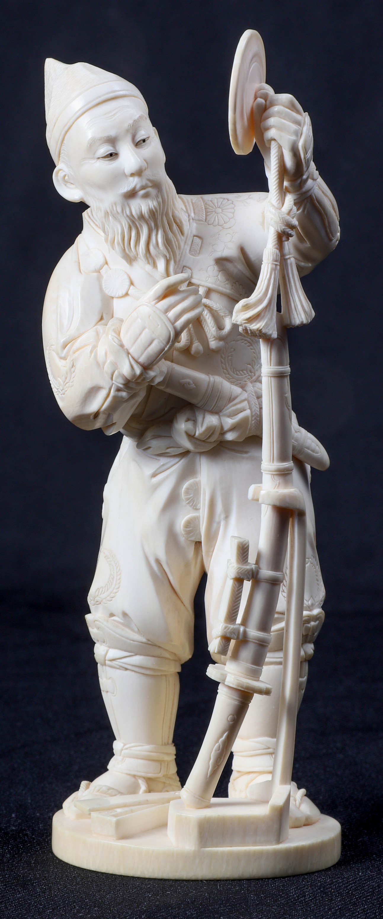 An ivory carved figure of a samurai,