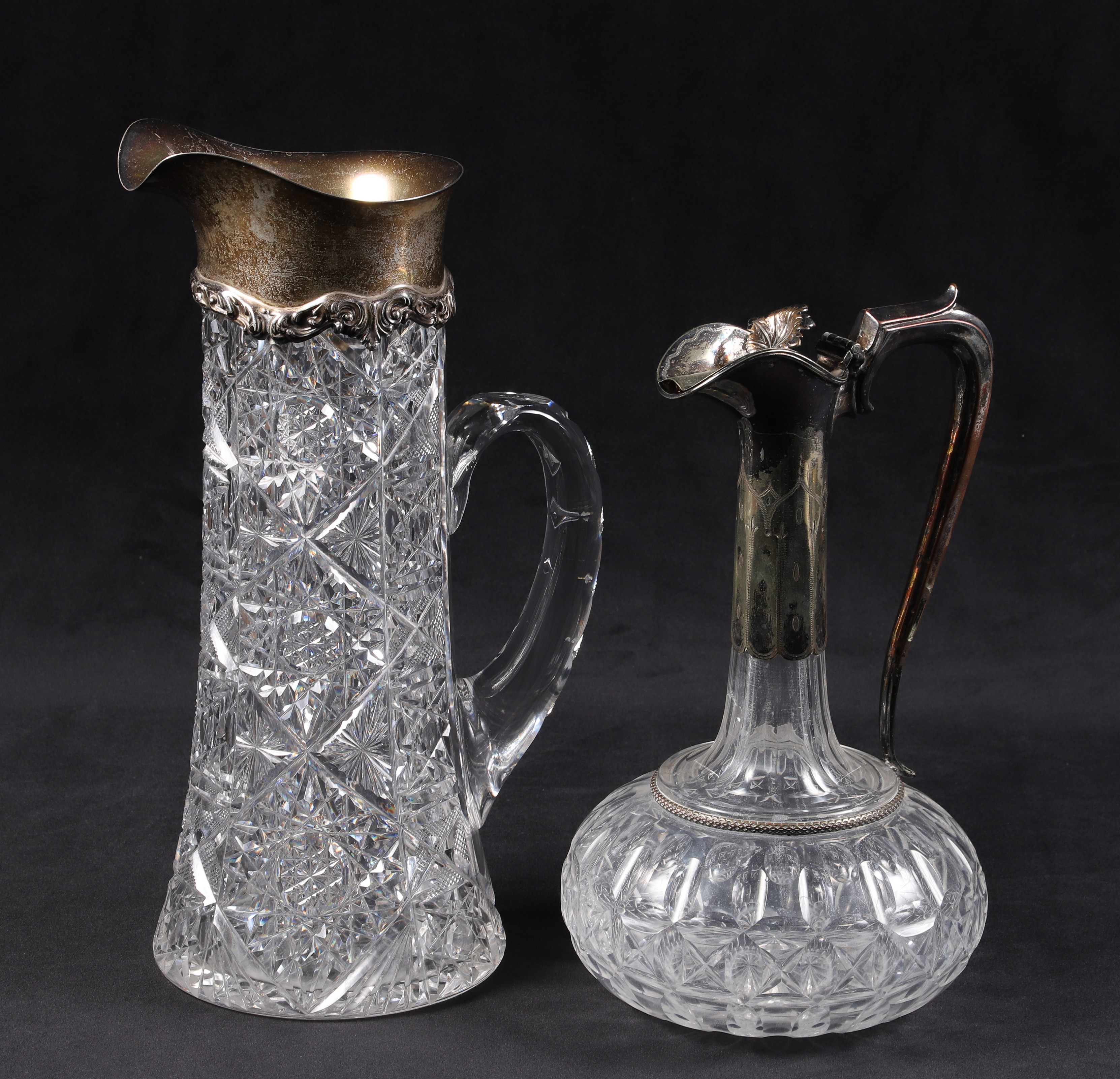 (2) Silver mounted cut glass pitchers,