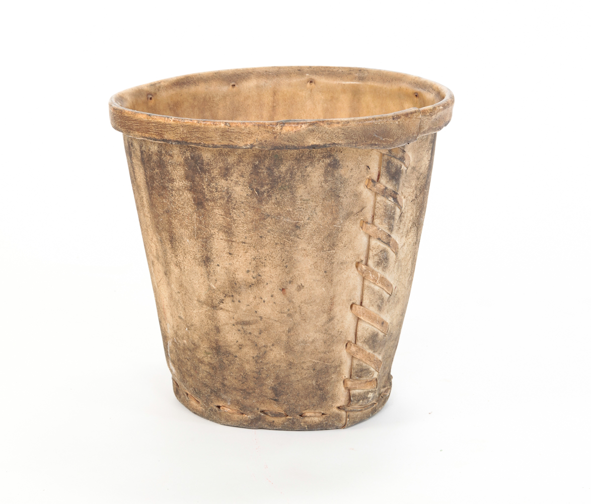 RAWHIDE WASTE BASKET. Most likely