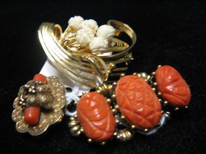 Three gold pins    Two with coral designs;