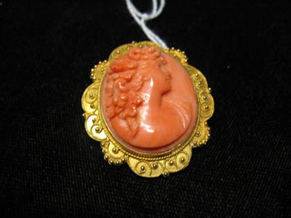 Coral cameo pin of a woman's dextral