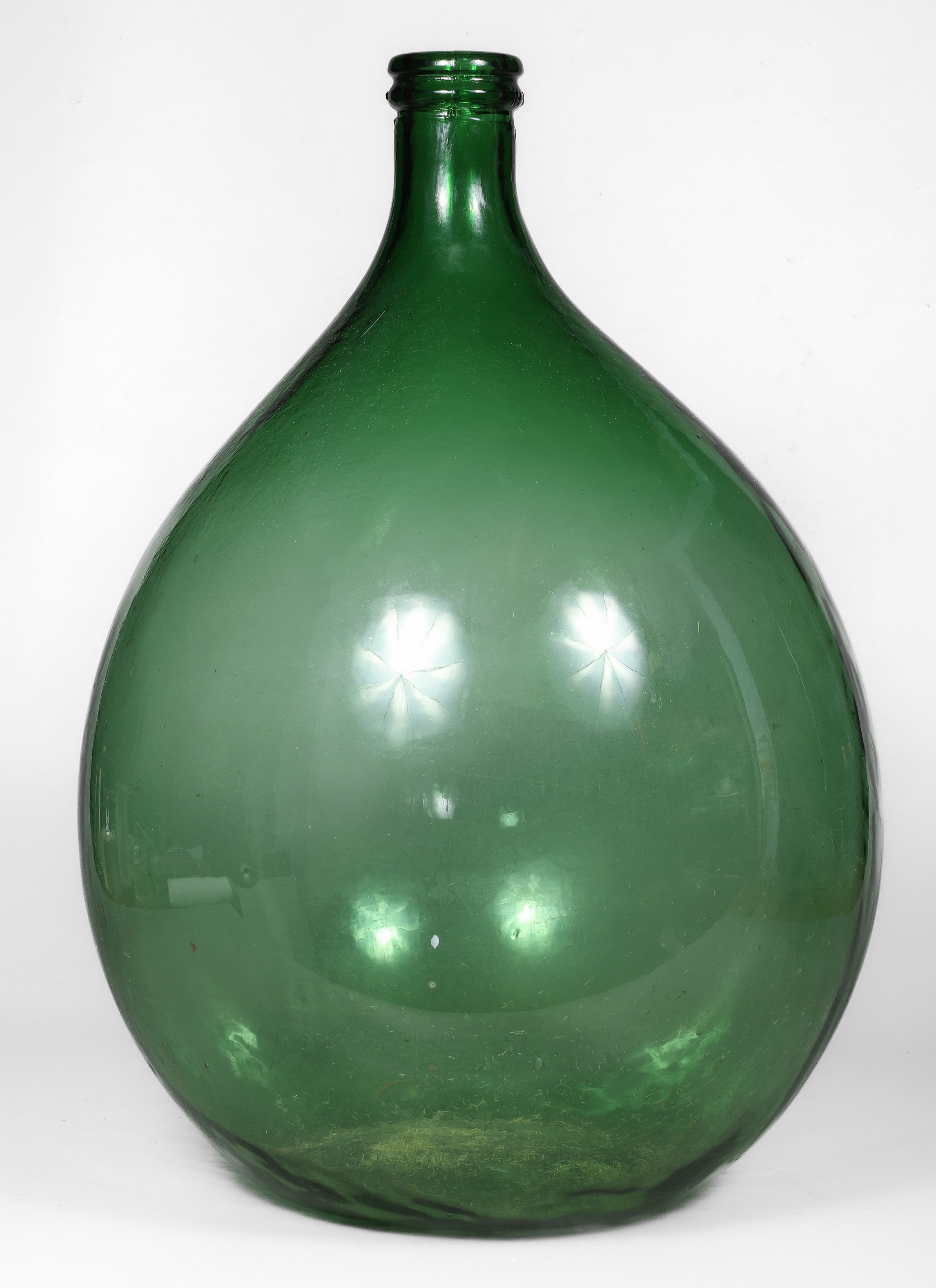 Large green molded glass demijohn