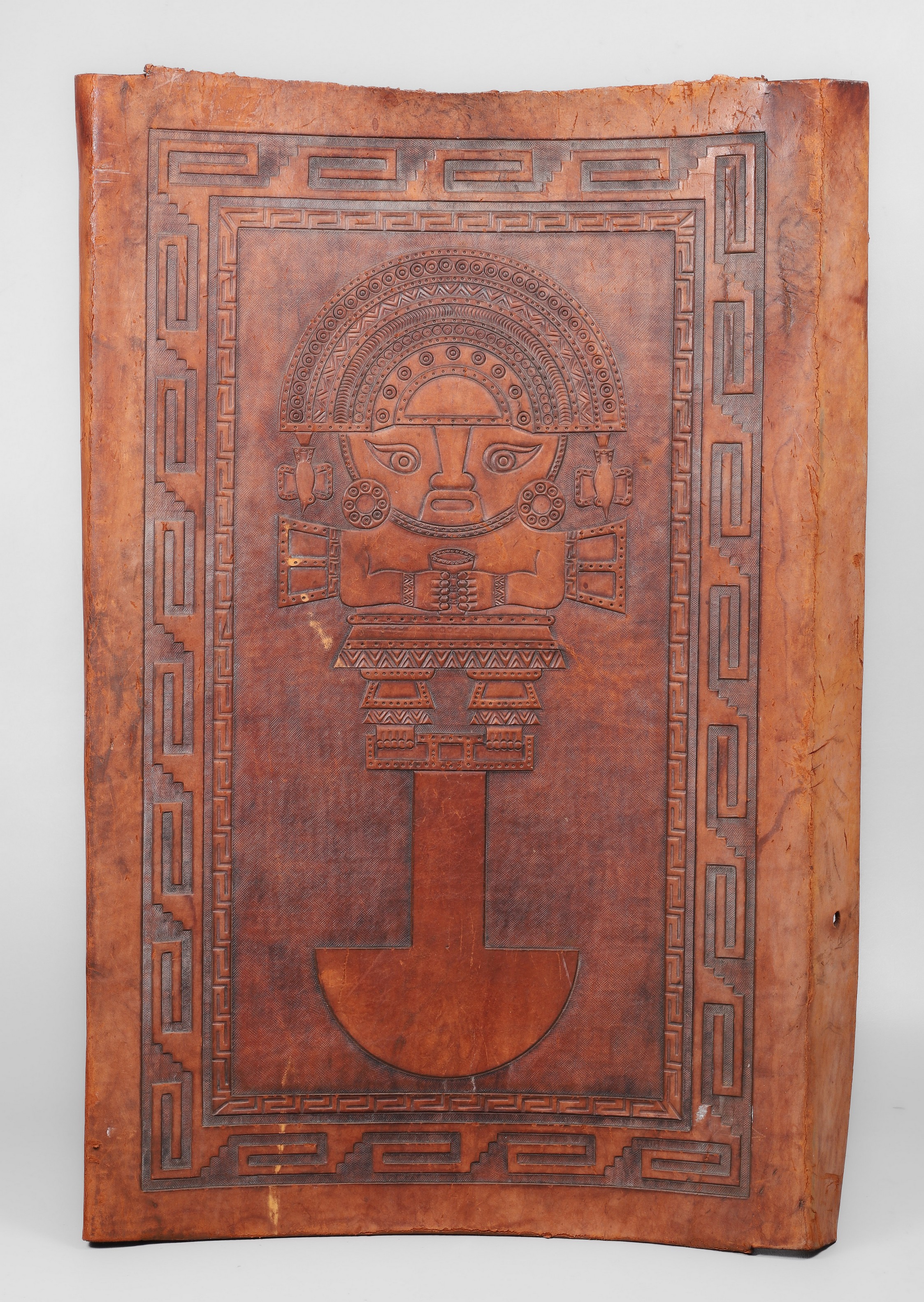A tooled leather Aztec style chairback,