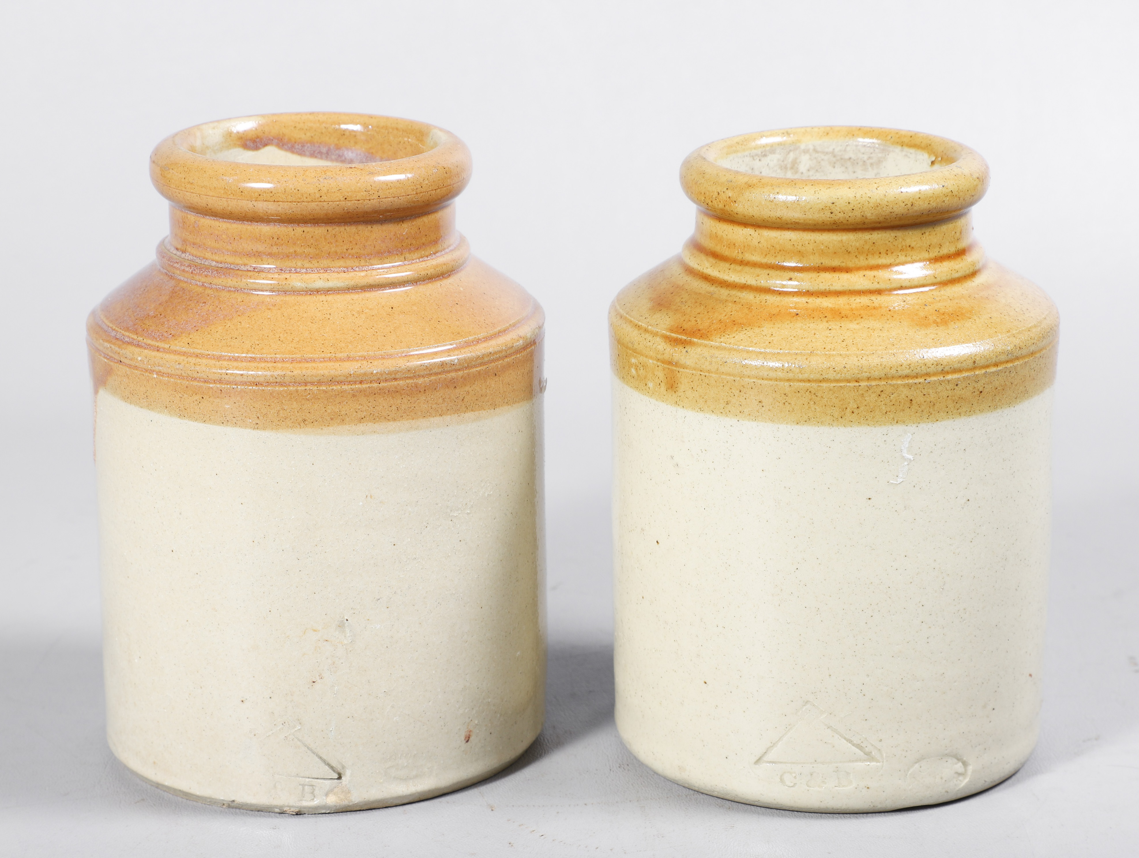 A pair of yellow glazed stoneware jars,
