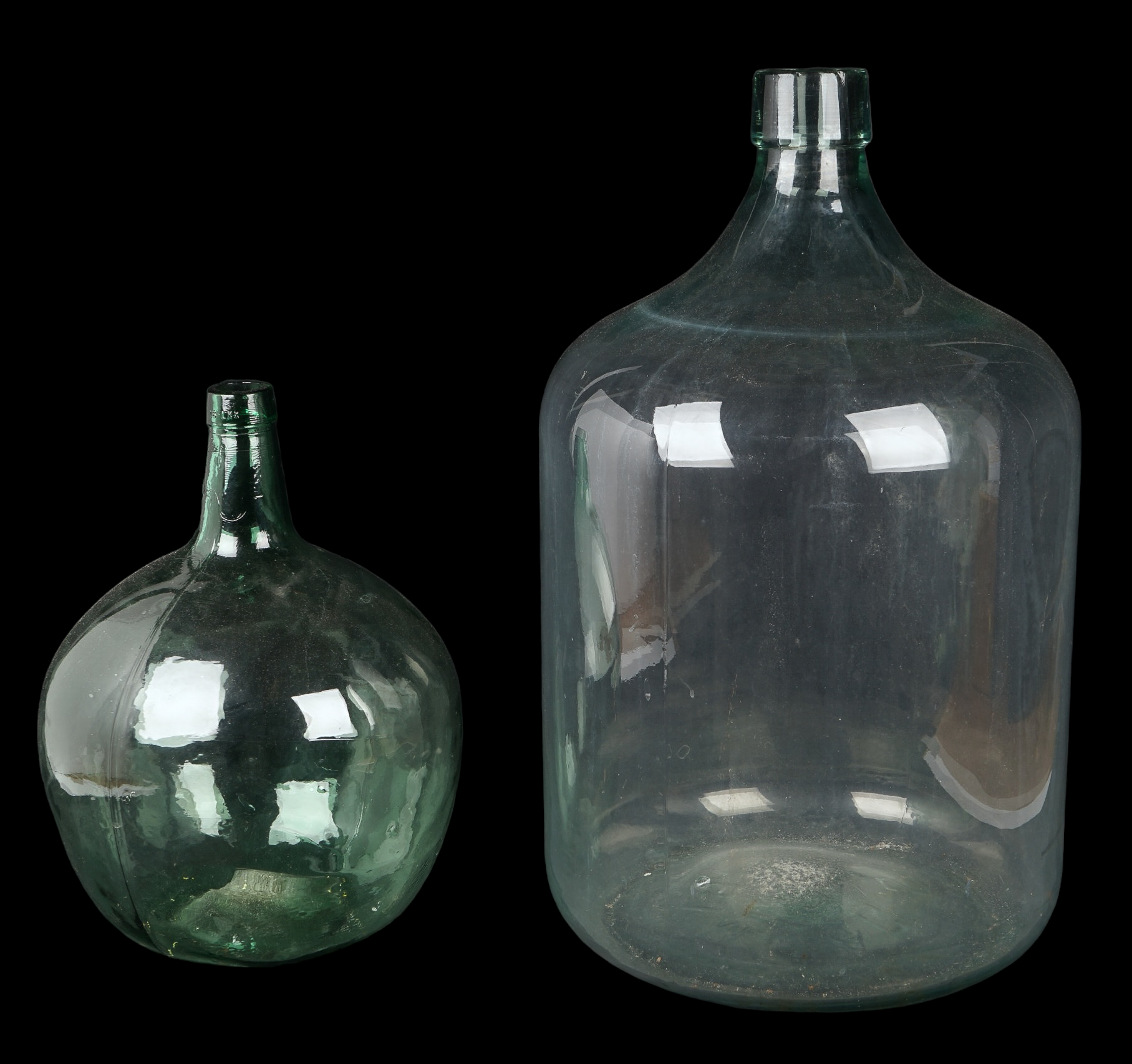 (2) Aqua green glass demijohns,