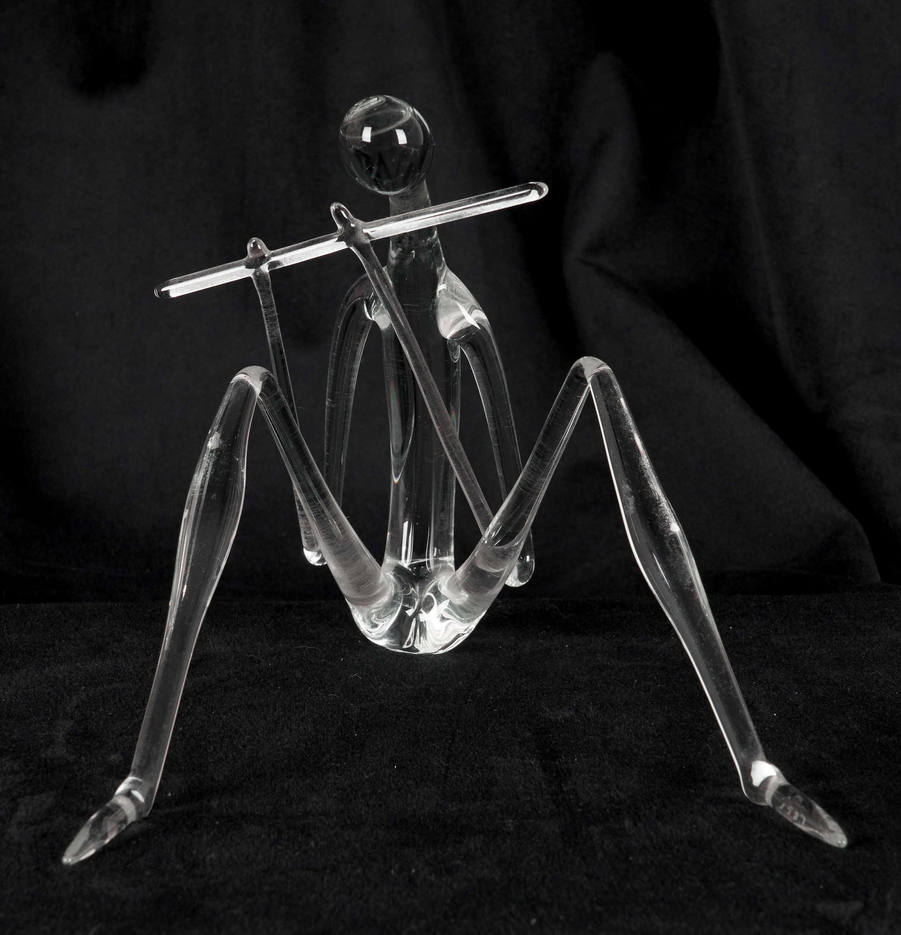 Delicate glass art sculpture, man sitting