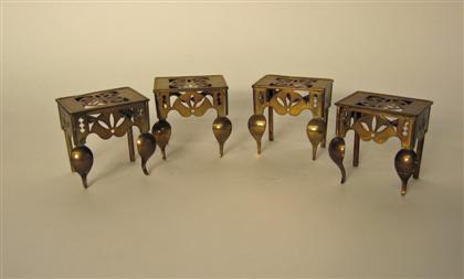 Set of four miniature brass footman