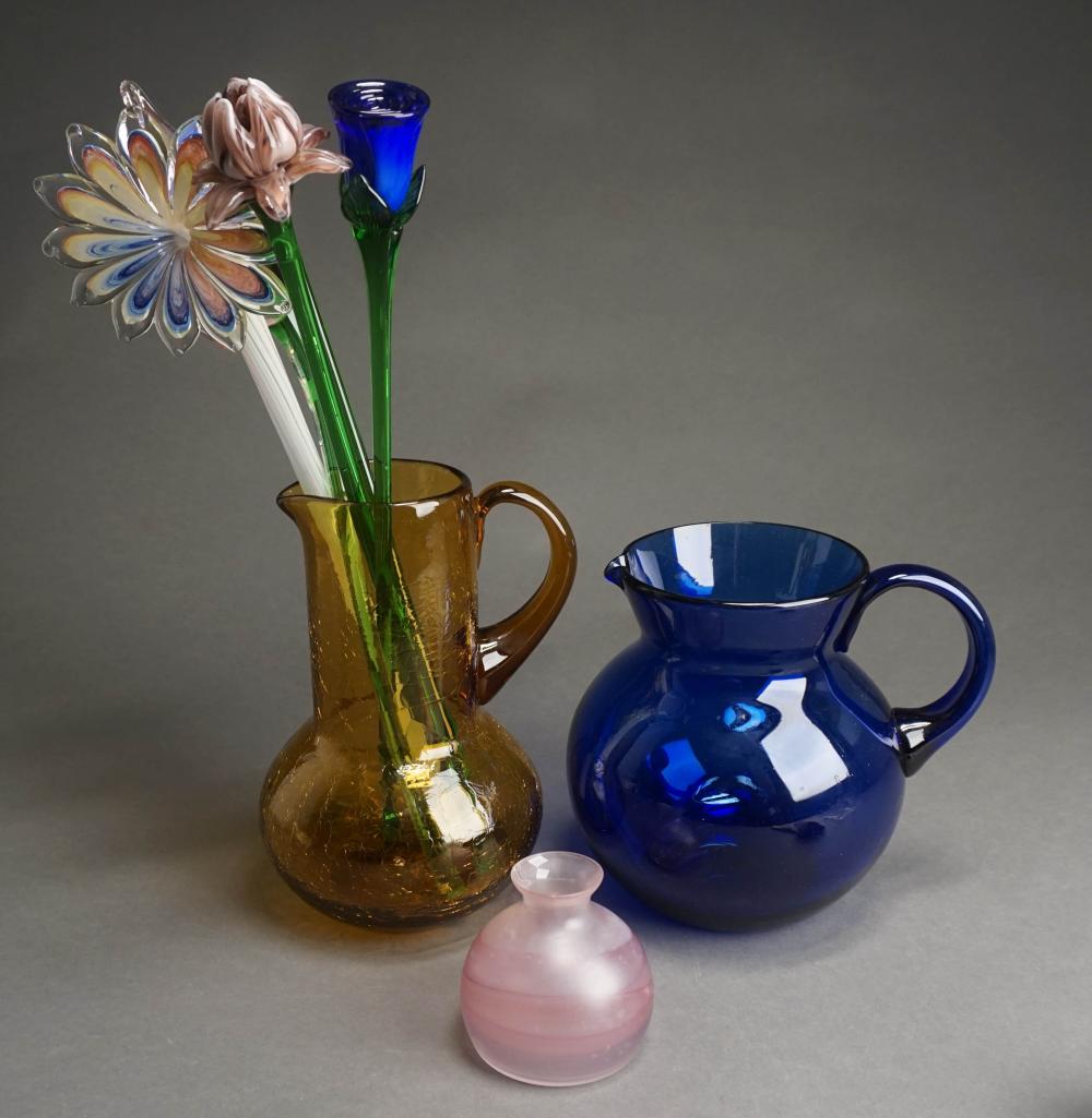 TWO COLORED GLASS PITCHERS, FLOWERS