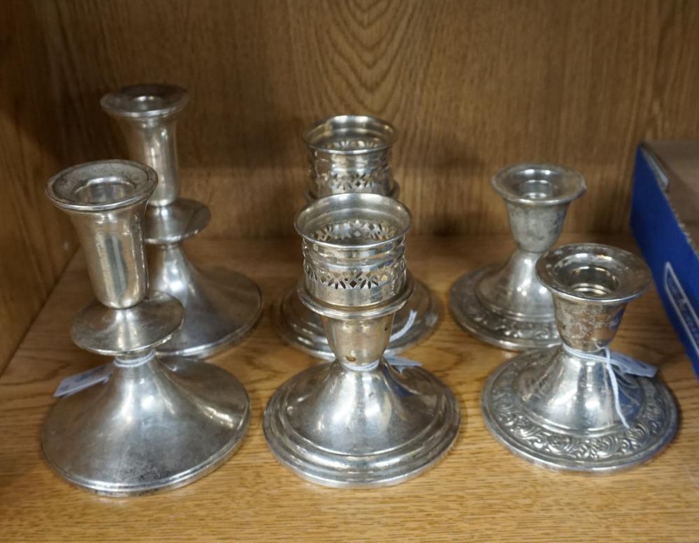 THREE WEIGHTED STERLING SILVER CANDLESTICKS,