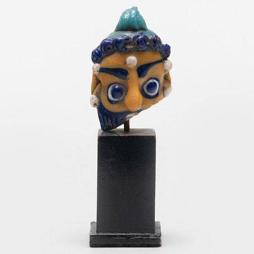 PHOENICIAN GLASS FACE BEAD ON STAND1