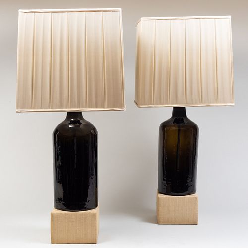 PAIR OF BLACK GLAZED LAMPS ON WOVEN