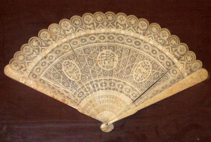 Carved ivory fan    Mounted in a shadow