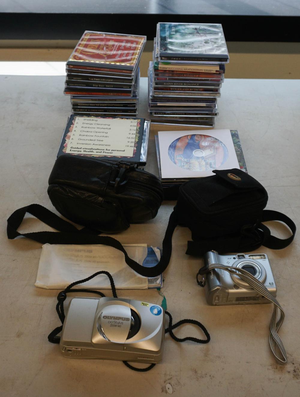 BOX OF CDS AND TWO CAMERASBox of CDs