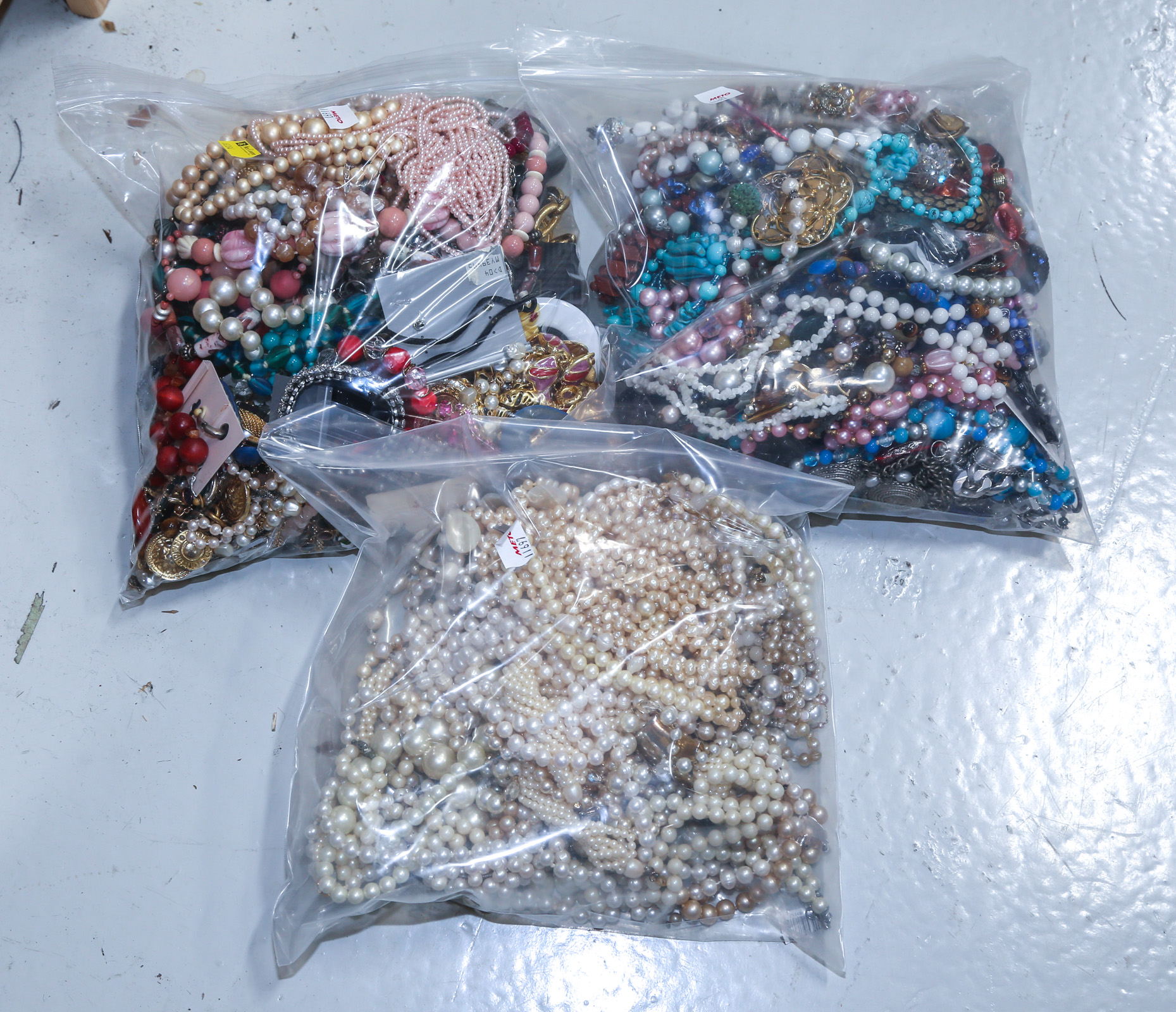 THREE BAGS OF COSTUME JEWELRY Comprising
