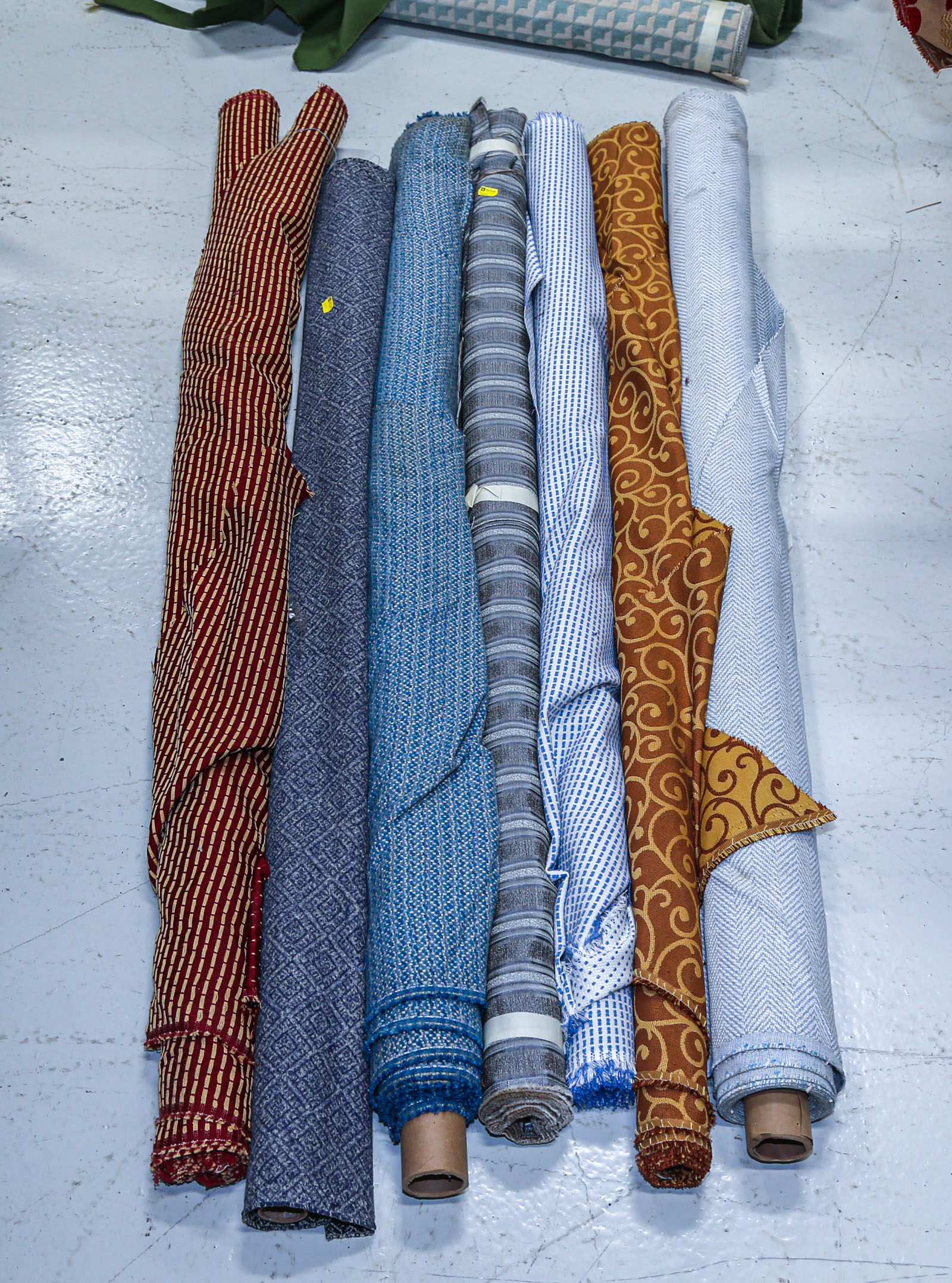 SEVEN BOLTS OF UPHOLSTERY FABRIC