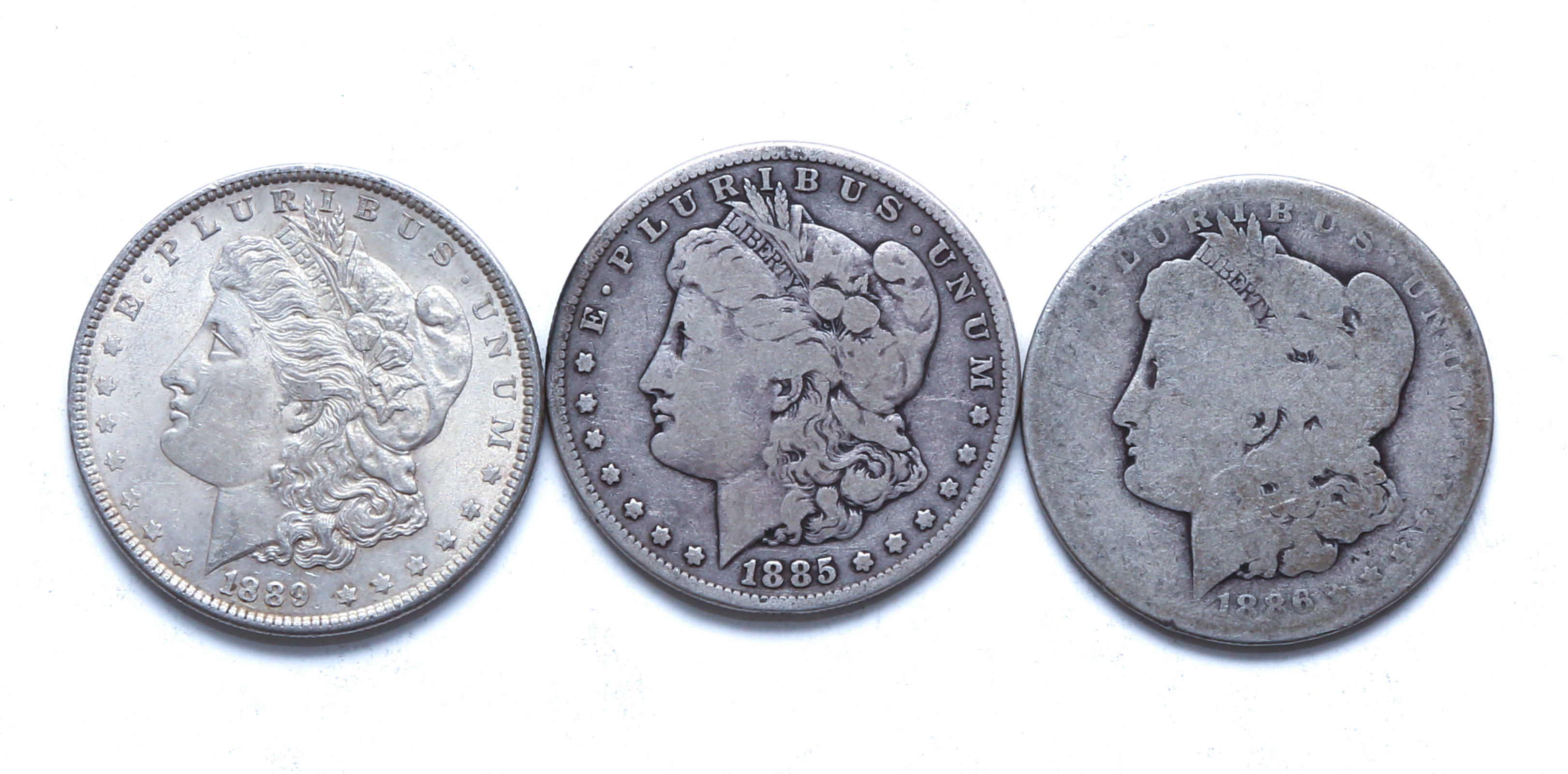 THREE MORGAN SILVER DOLLARS 1886 O 2ea66c