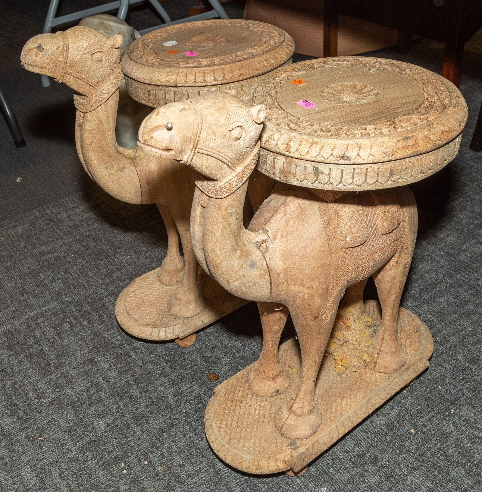 A PAIR OF CARVED WOOD CAMEL STANDS/