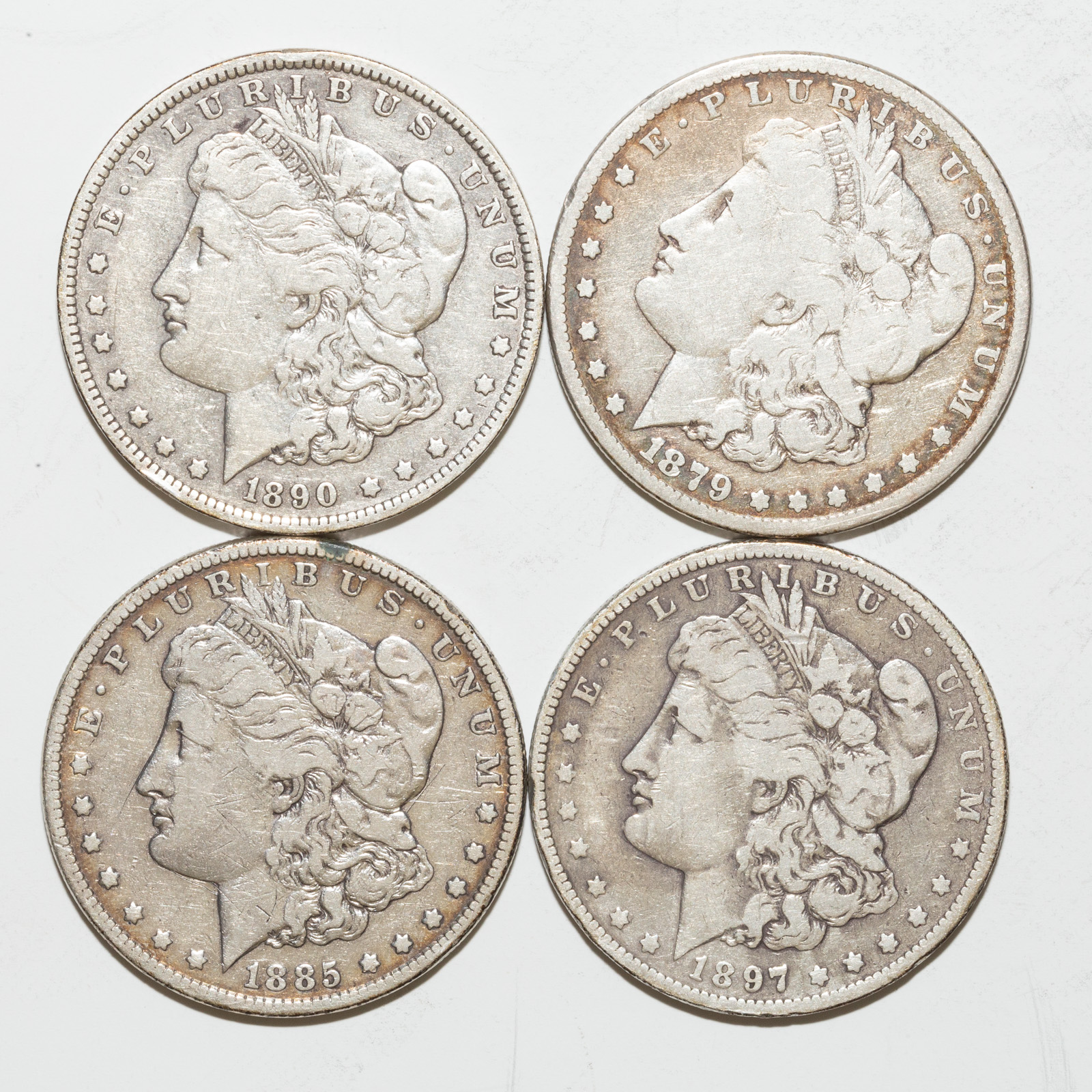 FOUR SILVER MORGAN DOLLARS 1879