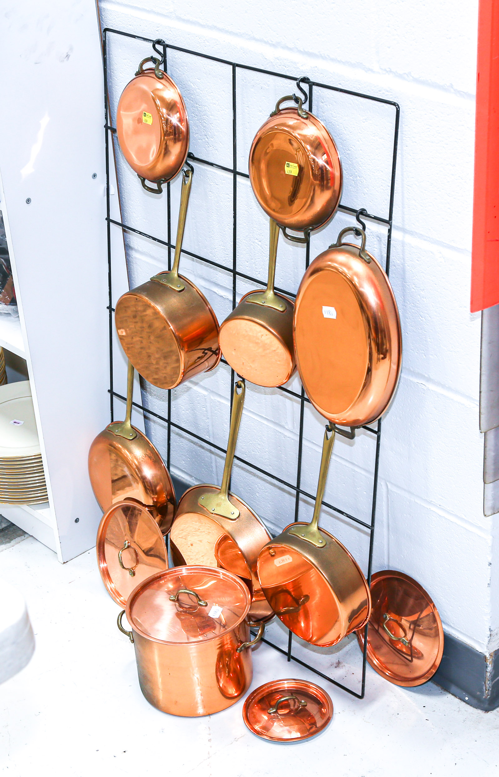 NINE COPPER COOKING POTS WITH IRON DISPLAY