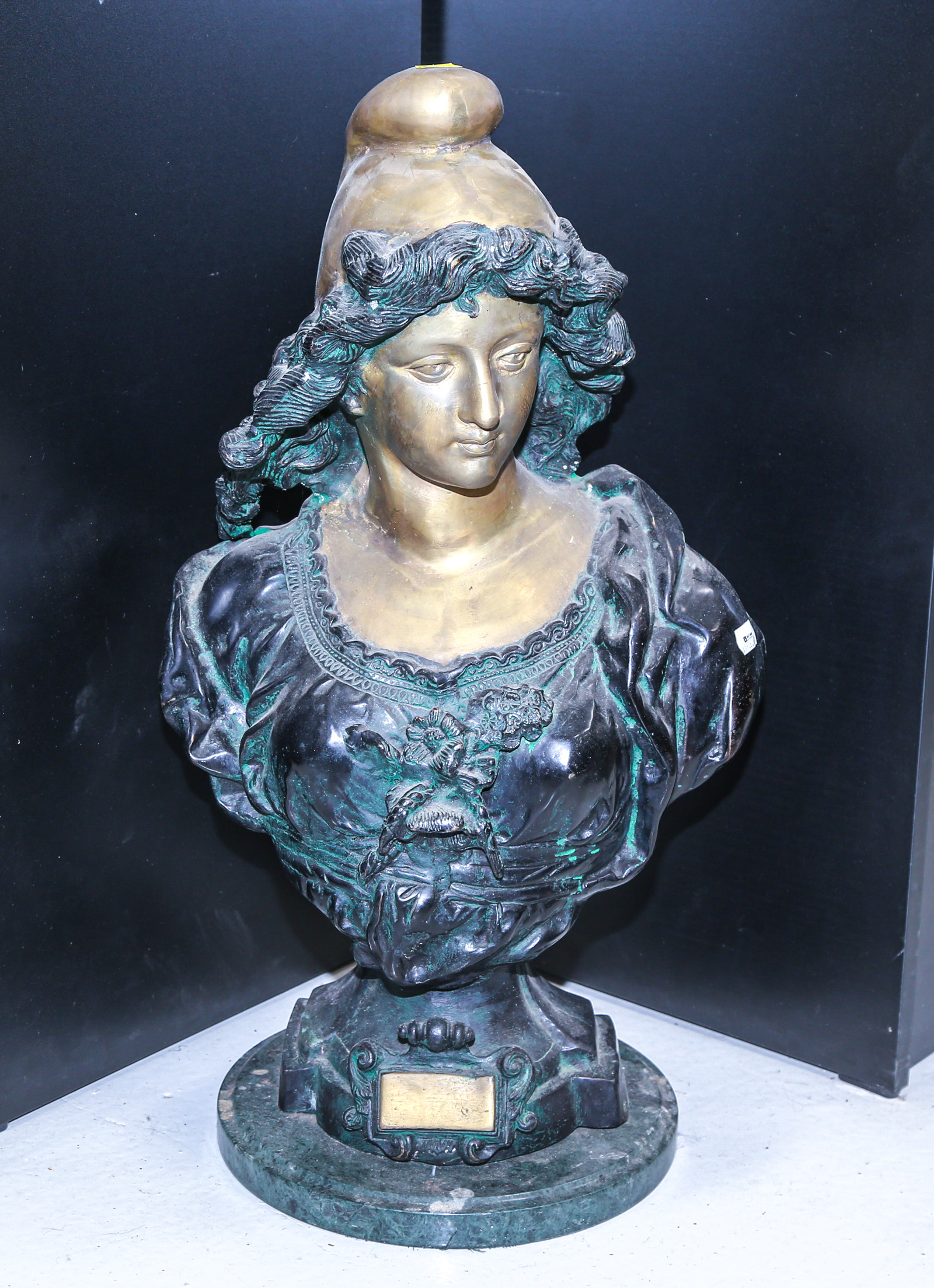 PATINATED BRONZE BUST OF A WOMAN Wearing